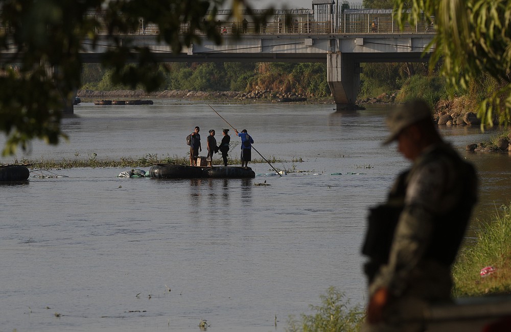 People travel across the Suchiate River, the natural border between Guatemala and Mexico, from Guatemala to Mexico, as Mexican immigration agents enforce limits on all but essential travel at its shared border, near Ciudad Hidalgo, Mexico, Monday, March 22, 2021. Mexican agents are forcing those with permission to enter Mexico to use the official border crossing bridge and others are being returned to Guatemala. (AP Photo/Eduardo Verdugo)
