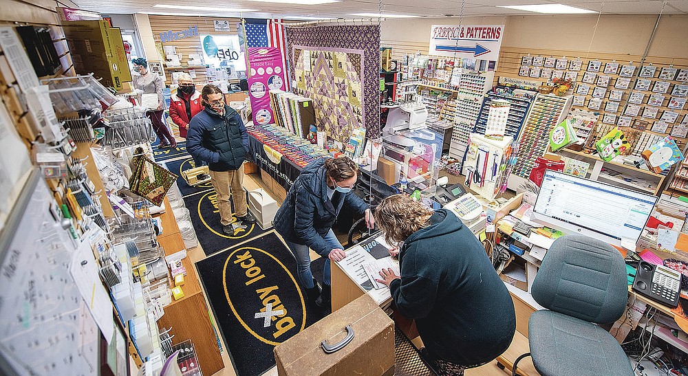 Customers wait in line to drop of their machines in need of repair at Klaiber's Sewing Center on March 3, 2021 in Bloomington, Ind. (Rich Janzaruk/The Herald-Times via AP)