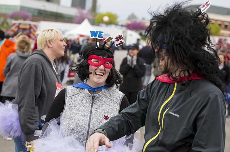 NWA Democrat-Gazette/BEN GOFF @NWABENGOFF
Tamarah Cole and husband Alex Cole of Rogers, with the Walmart team, have a laugh Saturday, April 13, 2019, before taking part in the Northwest Arkansas Heart Walk starting from the Walmart Arkansas Music Pavilion in Rogers. This year is the 25th anniversary for the American Heart Association's annual walk with locations around the country. This year's Northwest Arkansas walk raised more than $1 million with donations still coming in as of Saturday morning, said to Lauren Wheeler with the American Heart Association Northwest Arkansas.