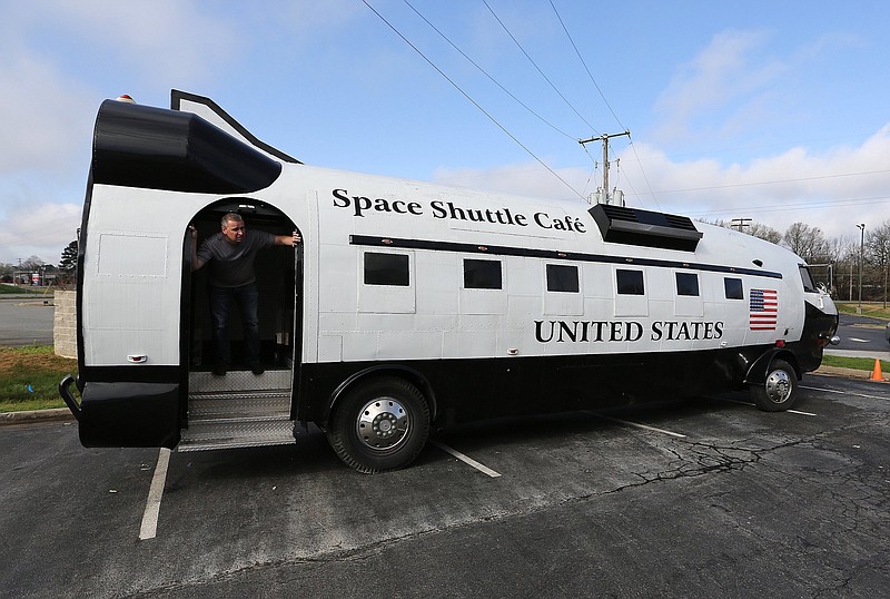 Chris Bailey, senior vice president of operations for Minute Man restaurants, exits the Space Shuttle Cafe food truck, which arrived last week at the Minute Man in Jacksonville. CEO Perry Smith says the 39-plus-foot mobile restaurant is in the "hangar," needing an engine rehab, along with work on the interior and the removal of a couple of dents that occurred in transit. (Arkansas Democrat-Gazette/Thomas Metthe)