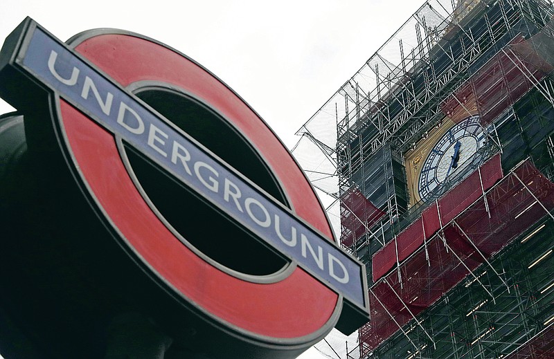 A London Underground sign at Westminster station with the Queen Elizabeth Tower in the background that holds the bell known as Big Ben in London, Monday, March 15, 2021. Even as many of its famous institutions closed during the coronavirus pandemic for most of the past 12 months, London's Underground kept running through three successive lockdowns. Nicknamed the Tube, its staff from cleaners to train drivers take pride in maintaining a system that keeps London's heart beating. (AP Photo/Alastair Grant)