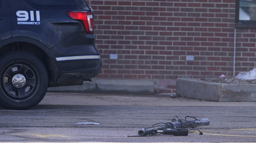 Debris lies in the parking lot outside a King Soopers grocery store where a mass shooting took place Tuesday, March 23, 2021, in Boulder, Colo. (AP Photo/David Zalubowski)