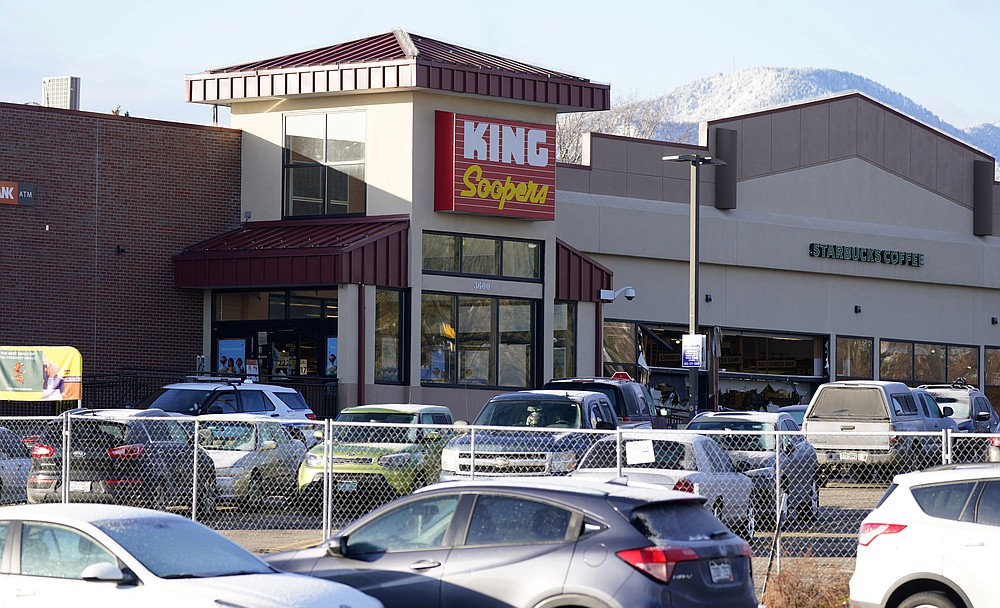 A makeshift fence stands around the parking lot outside a King Soopers grocery store where a mass shooting took place a day earlier in Boulder, Colo., Tuesday, March 23, 2021. (AP Photo/David Zalubowski)
