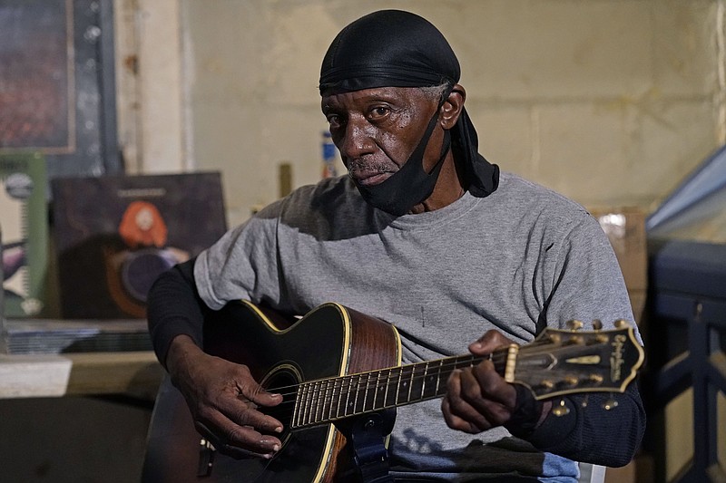Bluesman Jimmy “Duck” Holmes plays a quick ditty at the Blue Front Cafe in Bentonia, Miss. Holmes’ ninth album, “Cypress Grove,” earned a Grammy nomination for the best traditional blues album. (AP/Rogelio V. Solis)