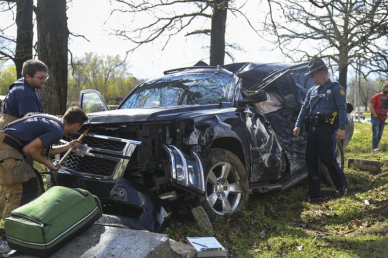 Members of Morning Star Fire Department and Arkansas State Police work the scene of a single-vehicle wreck in the 4800 block of Malvern Road on Thursday. - Photo by Grace Brown of The Sentinel-Record