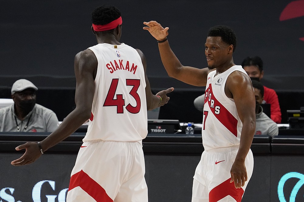Toronto Raptors guard Kyle Lowry (7) celebrates with forward Pascal Siakam (43) as the pair is taken out of the game against the Denver Nuggets during the second half of an NBA basketball game Wednesday, March 24, 2021, in Tampa, Fla. (AP Photo/Chris O'Meara)