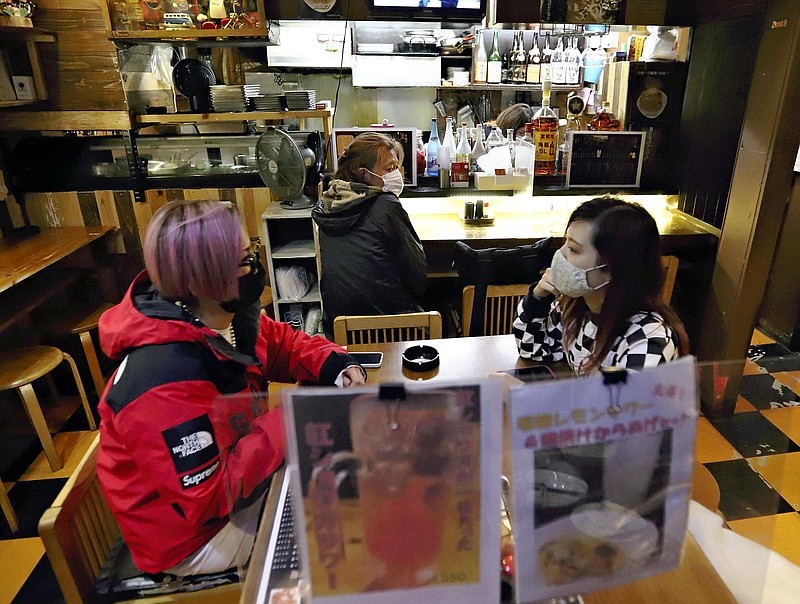 Customers are seen at a deep-fried skewered food restaurant in Shinjuku Ward, Tokyo, on Monday evening, after the closing time was extended following the end of the state of emergency. MUST CREDIT: Japan News-Yomiuri photo