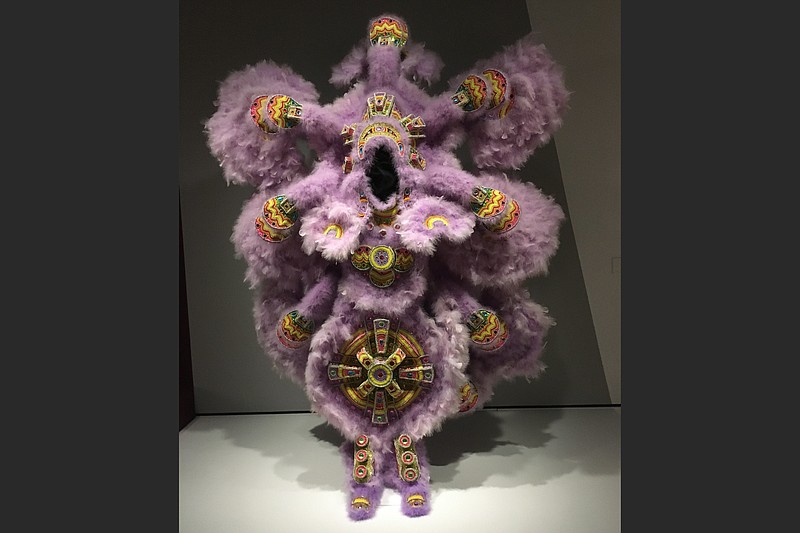 It can take 5,000 hours — or a year — to make a Carnival suit like “Circle Dance — A Tribute to John Scott,” a costume fashioned by Darryl Montana, Chief of the Yellow Pocahontas “Hunters” Black “masking” Indian Tribe in New Orleans. The costume is part of “Crafting America,” the exhibition continuing at Crystal Bridges Museum of American Art in Bentonville. (Arkansas Democrat-Gazette/Philip Martin)