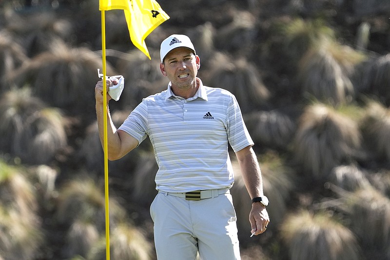 Sergio Garcia, of Spain, celebrates as he take his ball out of the cup after making a hole in one on the fourth hole to win his playoff against Lee Westwood, of England, during a third round match at the Dell Technologies Match Play Championship golf tournament Friday, March 26, 2021, in Austin, Texas. (AP Photo/David J. Phillip)