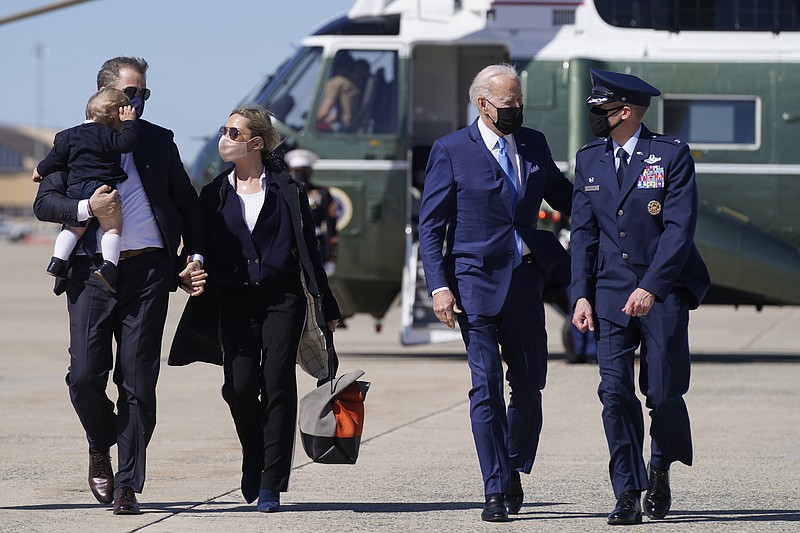 President Joe Biden walks with his son Hunter Biden, left, as Hunter carries his son Beau and holds his wife Melissa Cohen's hand before boarding Air Force One at Andrews Air Force Base, Md., Friday, March 26, 2021. (AP Photo/Patrick Semansky)