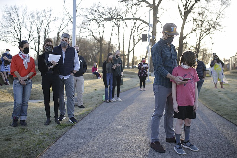 Attendees recite a poem, Friday, March 26, 2021 at The Momentary in Bentonville. People gathered for a Stop Asian Hate vigil to stand against racism and discrimination. Check out nwaonline.com/210327Daily/ for today's photo gallery. 
(NWA Democrat-Gazette/Charlie Kaijo)