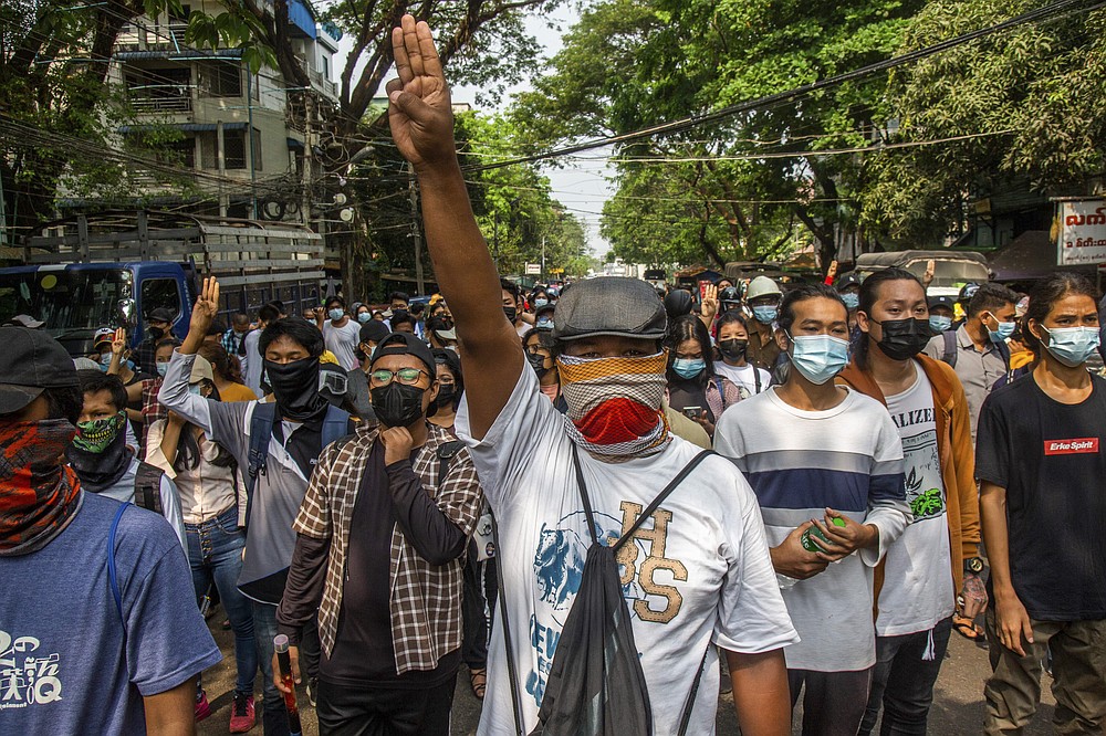 Anti-coup protesters gesture with a three-fingers salute, a symbol of resistance during a demonstration in Yangon, Myanmar, Saturday March 27, 2021. The toll of protesters confirmed killed in Myanmar since last month’s military takeover has reached 320, a group that verifies details of deaths and arrests announced Friday. (AP Photo)