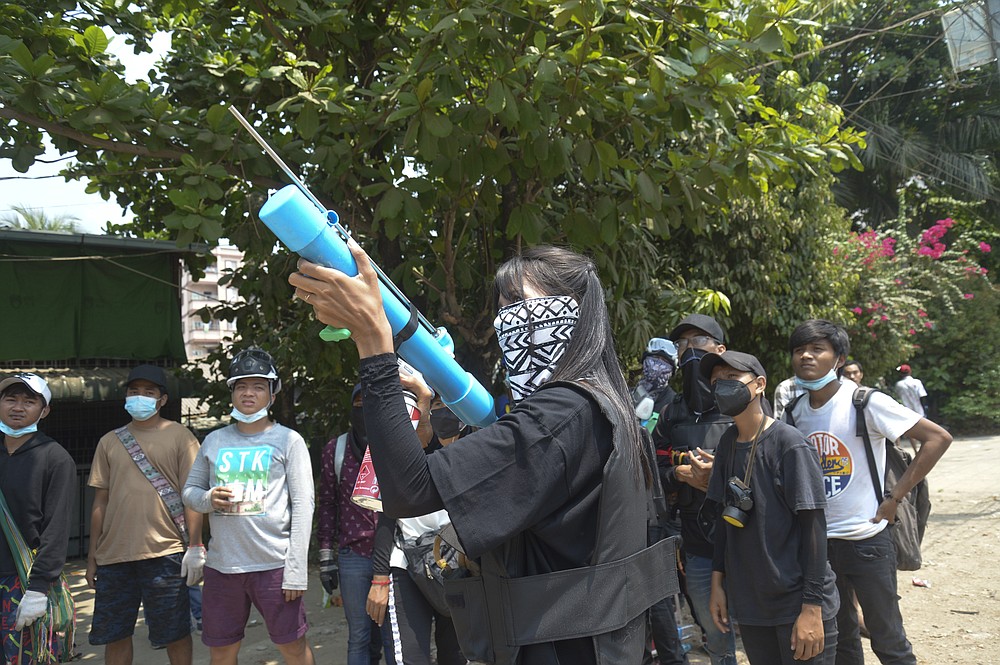 Anti-coup protesters prepare with makeshift airgun during police crackdown at Thaketa township in Yangon, Myanmar, Saturday, March 27, 2021. The head of Myanmar’s junta has used the occasion of the country’s Armed Forces Day to try to justify the overthrow of the elected government of Aung San Suu Kyi, as protesters marked the holiday by calling for even bigger demonstrations. (AP Photo)