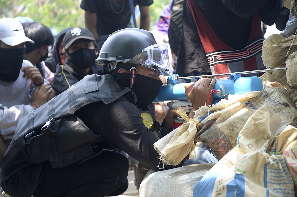 Anti-coup protesters prepare a makeshift airgun to confront police in Thaketa township Yangon, Myanmar, Saturday, March 27, 2021. The head of Myanmar’s junta on Saturday used the occasion of the country’s Armed Forces Day to try to justify the overthrow of the elected government of Aung San Suu Kyi, as protesters marked the holiday by calling for even bigger demonstrations. (AP Photo)