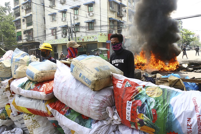 Anti-coup protesters take positions behind their makeshift barricade in a protest in Yangon, Myanmar, Sunday, March 28, 2021. Protesters in Myanmar returned to the streets Sunday to press their demands for a return to democracy, just a day after security forces killed more than 100 people in the bloodiest day since last month's military coup. (AP Photo)