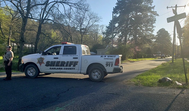 A Garland County sheriff's deputy blocks the Whittington Avenue end of Blacksnake Road at Newton Sunday evening, March 28. - Photo by Grace Brown of The Sentinel-Record