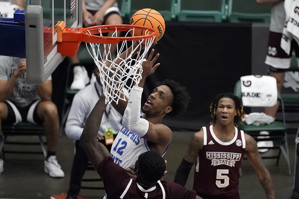 Memphis forward DeAndre Williams, center, takes a shot over Mississippi State forward Abdul Ado, left, in the first half of an NCAA college basketball championship game in the NIT, Sunday, March 28, 2021, in Frisco, Texas. (AP Photo/Tony Gutierrez)