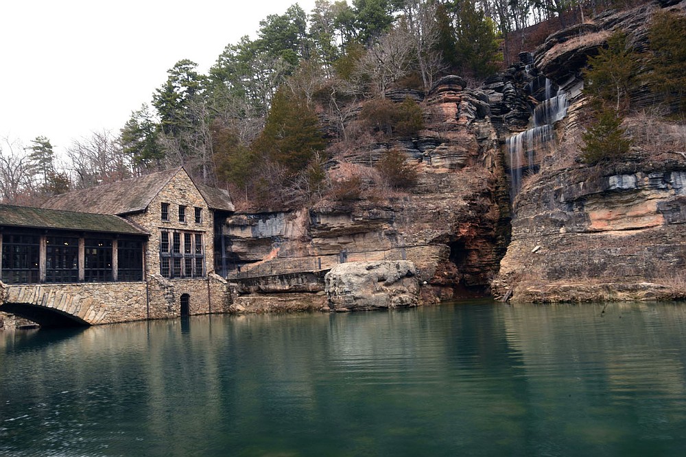 VIsitors are greeted to waterfalls as soon as they enter the park. A cascade spills here Feb. 26 2021 near the grist mill and restaurant at the nature park entrance.
(NWA Democrat-Gazette/Flip Putthoff)