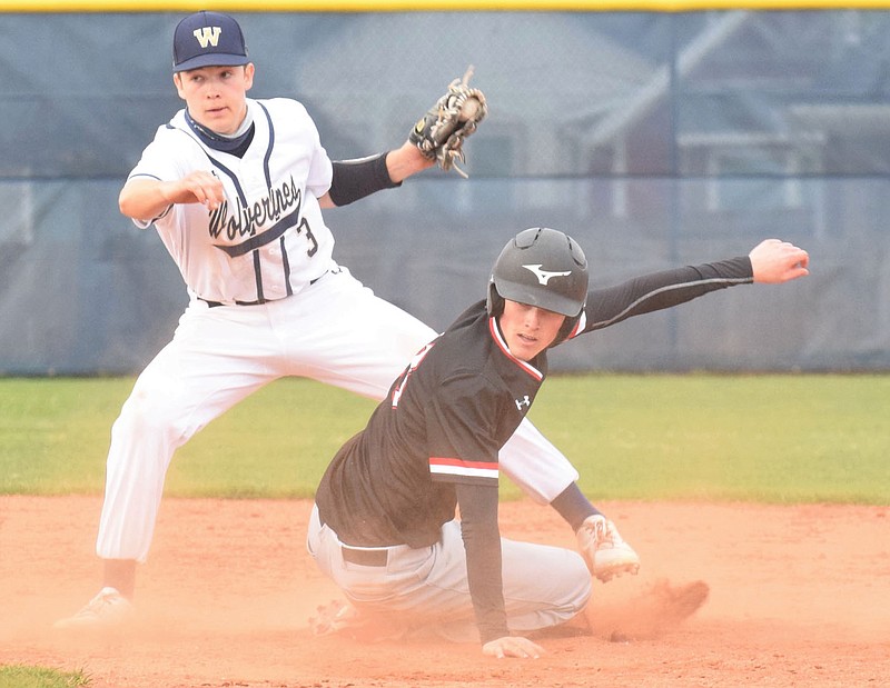 RICK PECK/SPECIAL TO MCDONALD COUNTY PRESS McDonald County's Wade Rickman is called out while attempting to steal second base during the Mustangs 5-1 loss to Bentonville West on March 24 at Bentonville West High School.