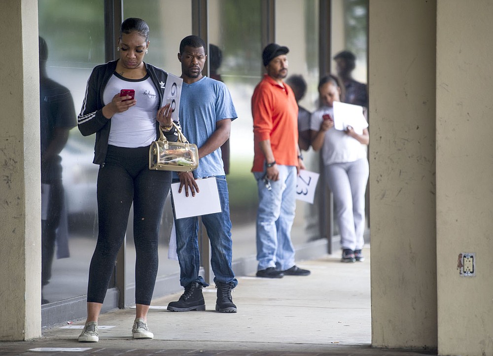 Applicants wait in line to file for unemployment in May 2020. Many who found themselves without jobs during the pandemic waited months for their unemployment applications to be processed and even longer to receive any money, sending them to search for other ways to keep their families housed and fed. For some, mutual aid organizations were the answer.
(Arkansas Democrat-Gazette file photo)