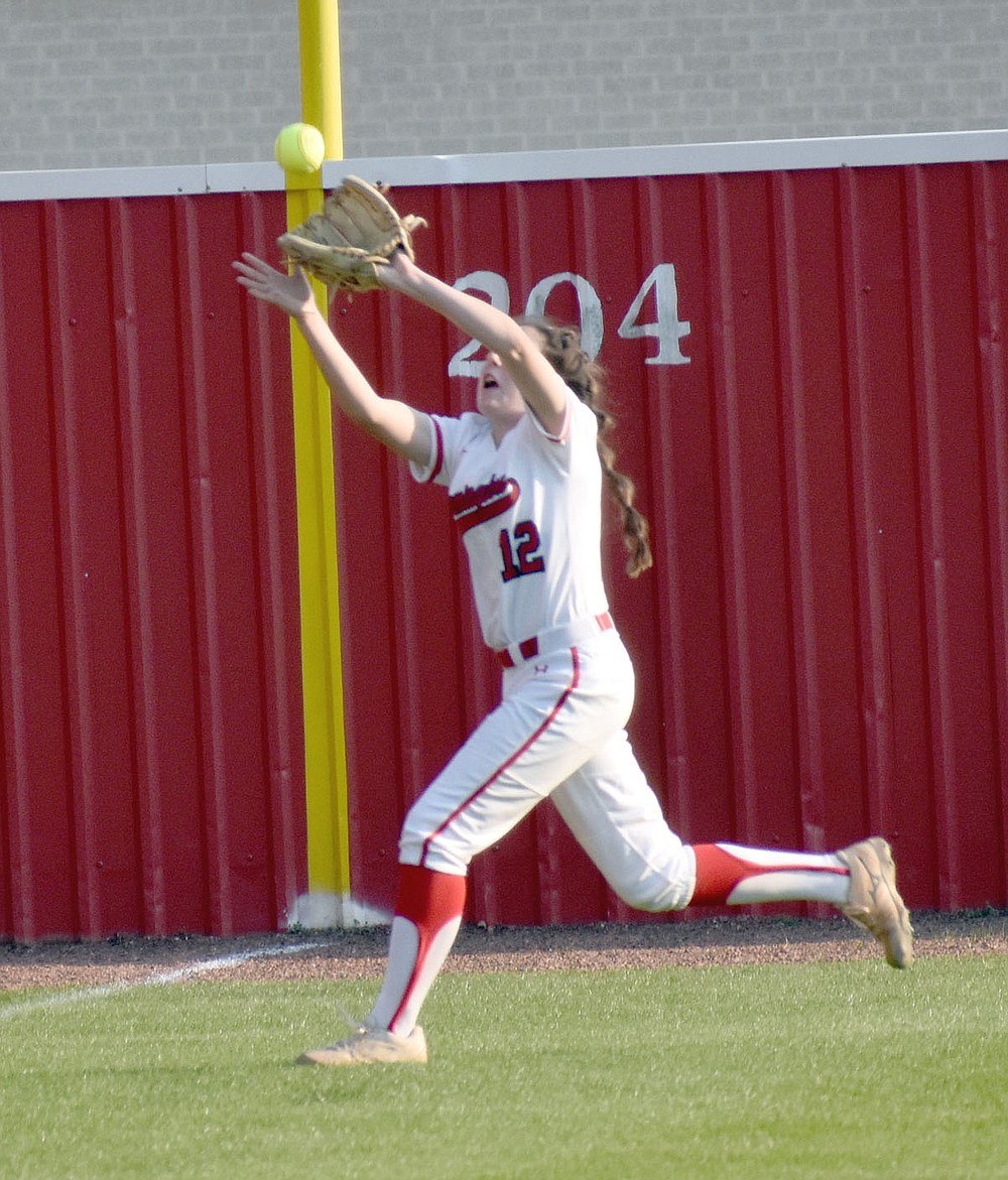 MARK HUMPHREY ENTERPRISE-LEADER/Farmington freshman Mary Lauren Bradley makes a catch in left field on the run. Farmington coach Randy Osnes inserted several reserves and still found a way to knock off previously unbeaten Bentonville West, 9-7, on Monday, March 29.
