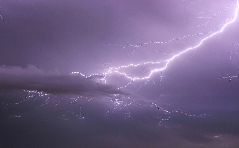 FILE -- Lightning shoots across the sky above downtown Fayetteville. (Photo by Michael Woods)