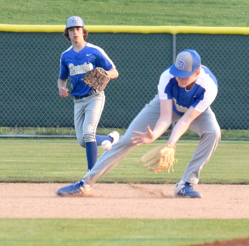 Westside Eagle Observer/MIKE ECKELS
Bryson Funk (right) scoops up a ground ball hit into center field during the Thaden-Decatur variety baseball contest at the Tyson Baseball Complex in Springdale March 29. The Bulldogs lost to the Barnstormers 5-2 in a non-conference contest.