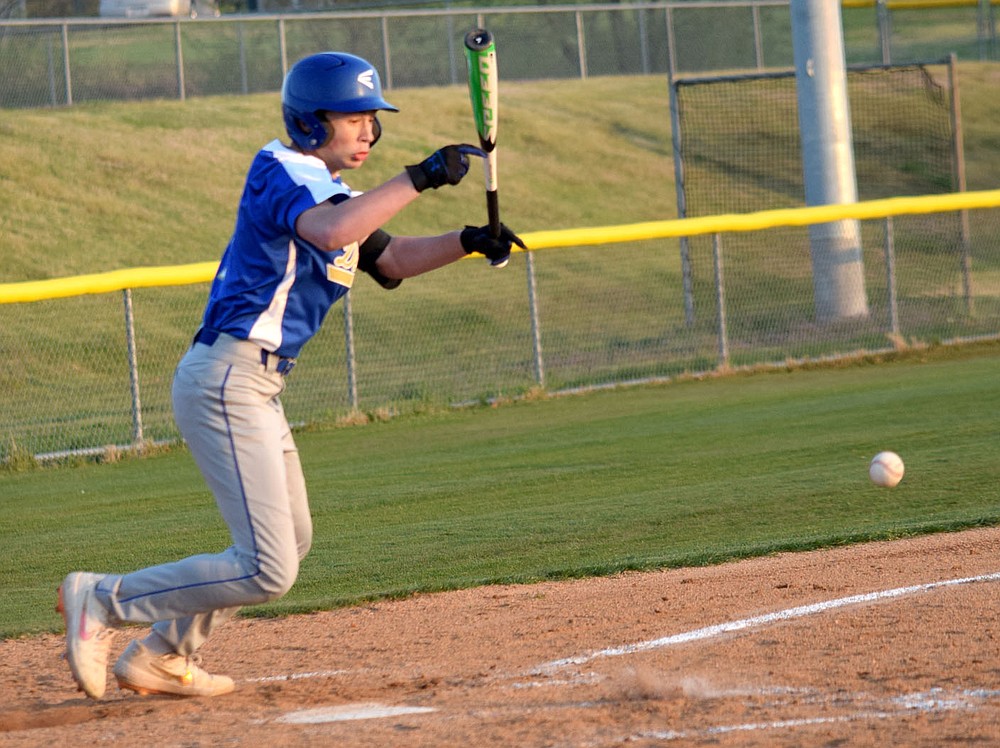 Westside Eagle Observer/MIKE ECKELS
Bulldogs batter Landon Watson bunts the ball to the left side of the infield during the third inning of the Thaden-Decatur ball game in Springdale March 29. Watson was out at first but his hit advanced the Bulldog runner from second to third base setting up a run for Decatur.