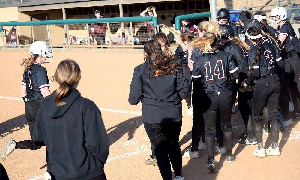 Westside Eagle Observer/MIKE ECKELS
The entire Lady Lions dugout stands along the third base line as Brook Handle (4 left) runs toward home plate after she hit a three run homer over the left field wall during the Gravette-Siloam Springs softball contest in Gravette Thursday night.