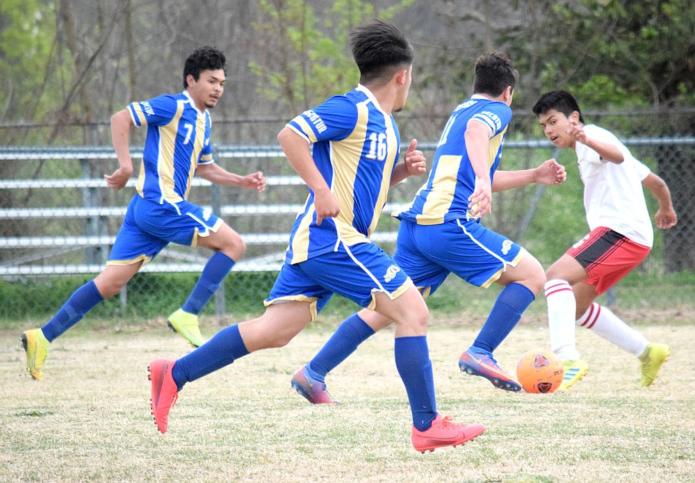 Westside Eagle Observer/MIKE ECKELS
A pack of Bulldogs on the move! A Highlander player (far right) tries to stop the advancing Dogs led by Roger Hernandez (second from right) with Christian Ramirez (16) and Steven Lucero (7) watching his back. Decatur took the conference win 6-1 over Eureka Springs at Bulldog Stadium in Decatur for the first home match of the 2021 season.