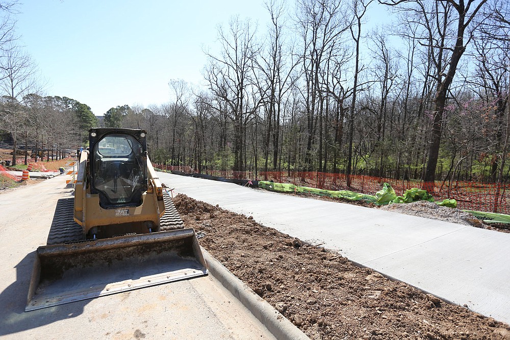 A new sidewalk is visible as infrastructure work continues Thursday, April 1, 2021, on the first phase of the development on Markham Hill near the intersection of Markham Road and Cross Avenue in Fayetteville. Check out nwadg.com/photos for a photo gallery.
(NWA Democrat-Gazette/David Gottschalk)