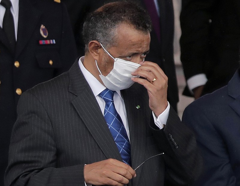 FILE - In this file photo dated Tuesday, July 14, 2020, Director General of the World Health Organization, Tedros Adhanom Ghebreyesus, adjusts his face mask during the Bastille Day military parade, in Paris. France.  More than 20 heads of government and global agencies have called for an international treaty for pandemic preparedness and response, that they say will protect future generations from future pandemics, with WHO's Tedros Adhanom Ghebreyesus and other leaders calling for countries to act cooperatively.  (AP Photo/Christophe Ena, FILE)