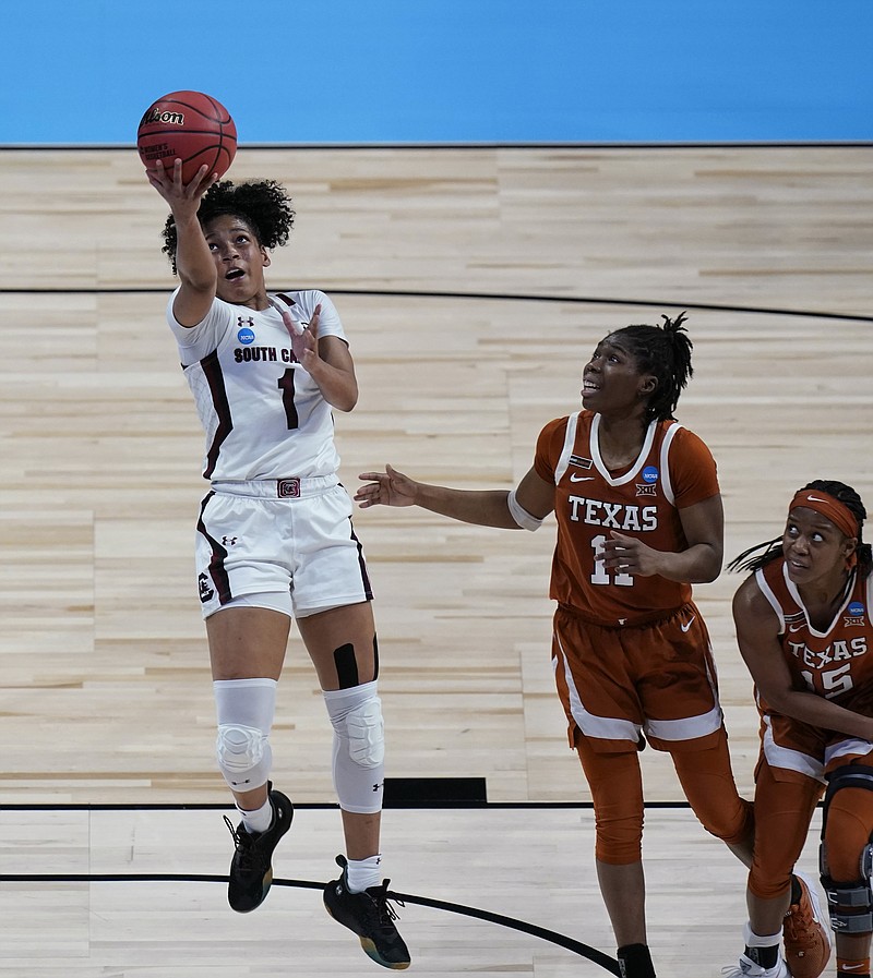 South Carolina guard Zia Cooke (1) drives to the basket past Texas guard Joanne Allen-Taylor (11) and guard Kyra Lambert (15) during the second half of a college basketball game in the Elite Eight round of the women's NCAA tournament at the Alamodome in San Antonio, Tuesday, March 30, 2021. (AP Photo/Eric Gay)