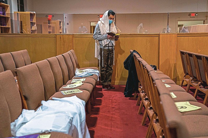 Elan Noorparvar, of Greenfield, prays during the daily morning prayer service at Shaare Torah on Friday, March 19, 2021, in the Squirrel Hill neighborhood of Pittsburgh, Pa. (Andrew Rush/Pittsburgh Post-Gazette via AP)