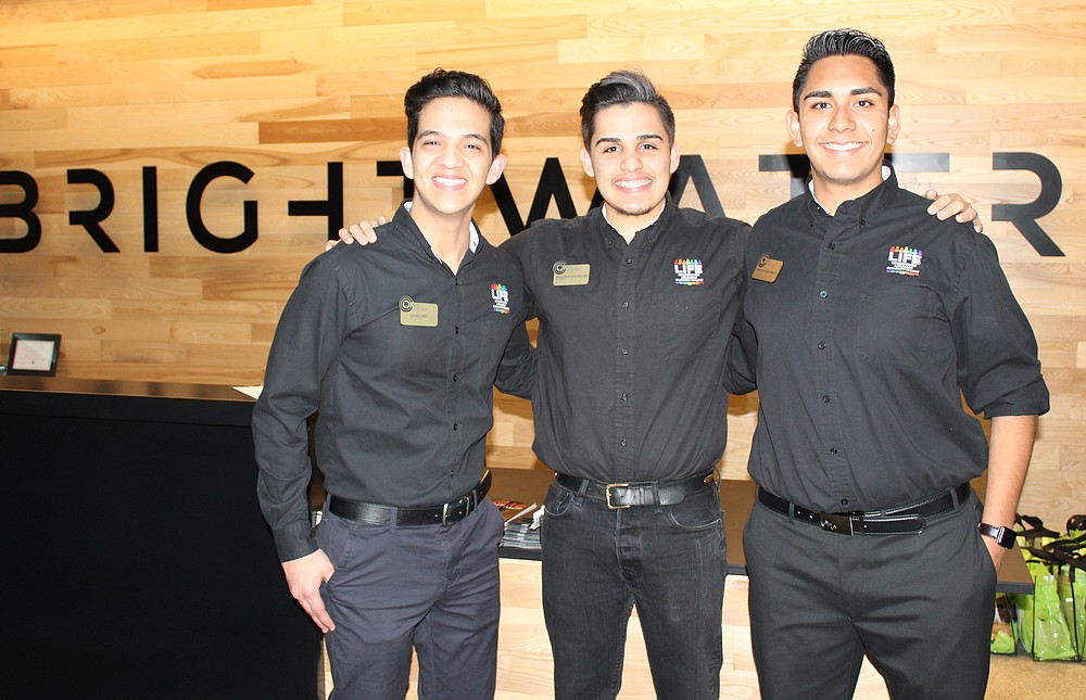 NWA Democrat-Gazette/CARIN SCHOPPMEYER Luis Gallardo (from left), Angel De La Calleros ans Emanuel Garcia Peralta, Northwest Arkansas Community College hospitality students, welcome guests to the Plant a Seed benefit April 27 at Brightwater: A Center for the Study of Food in Bentonville.