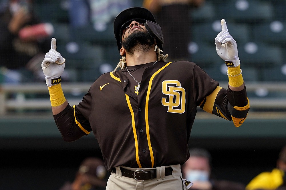 San Diego Padres' Fernando Tatis Jr. celebrates his solo home run during the first inning of a spring training baseball game against the Oakland Athletics, Friday, March 12, 2021, in Mesa, Ariz. (AP Photo/Matt York)
