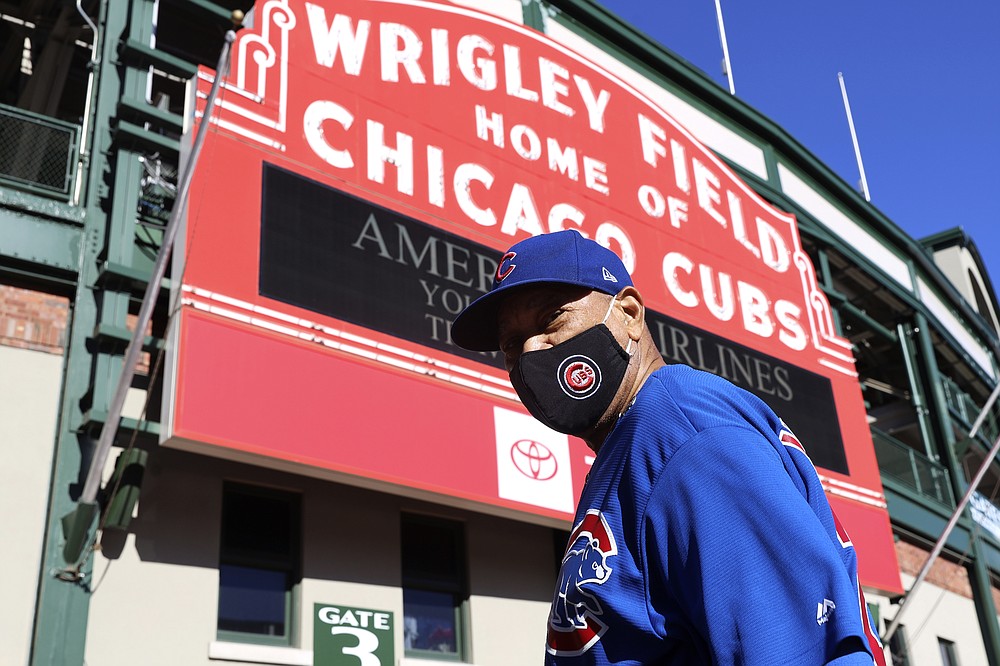 Chicago resident Charlie Moore, 80, poses for a portrait wearing the Chicago Cubs jersey at Wrigley Field on Thursday, March 11, 2021, in Chicago. With limitations, spectators will be allowed to return to the stands at Wrigley Field this season. (AP Photo/Shafkat Anowar)