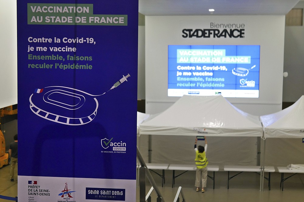 A banner reads « Vaccination at the Stade de France stadium » inside the Stade de France stadium where a Covid-19 vaccination centre will open on April 6, in Saint Denis, north of Paris, Wednesday, March 31, 2021. (AP Photo/Thibault Camus)