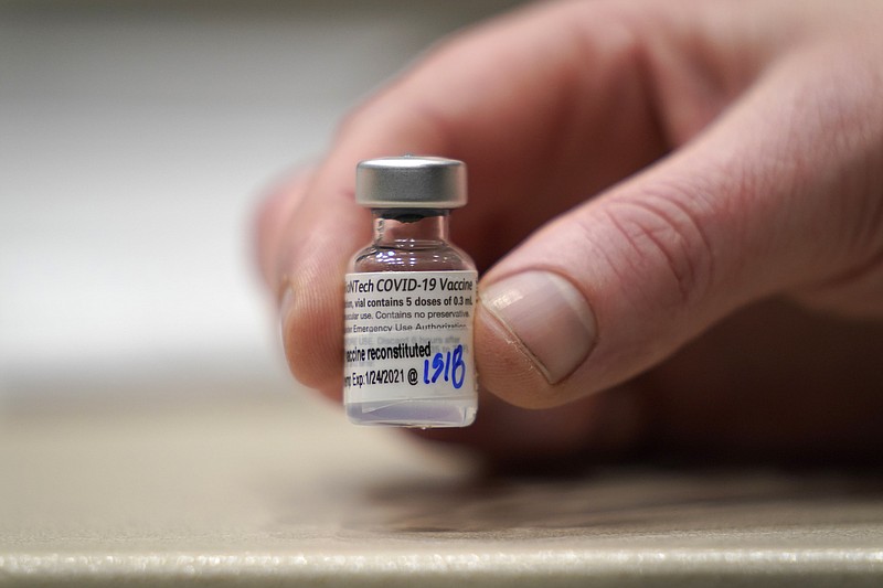 FILE - In this  Jan. 24, 2021, file photo, a vial of the Pfizer vaccine for COVID-19 is shown at a one-day vaccination clinic set up in an Amazon.com facility in Seattle and operated by Virginia Mason Franciscan Health. Pfizer announced Wednesday, March 31, 2021 that its COVID-19 vaccine is safe and strongly protective in kids as young as 12, a step toward possibly beginning shots in this age group before they head back to school in the fall. (AP Photo/Ted S. Warren, File)