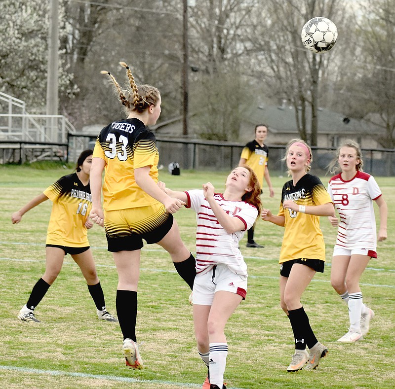 MARK HUMPHREY  ENTERPRISE-LEADER/A Dardanelle player nearly gets an unwanted facial as Prairie Grove freshman Emma Henry kicks the ball away from the Lady Tigers' goal during first half action of Prairie Grove's 3-2 win on Tuesday, March 30.