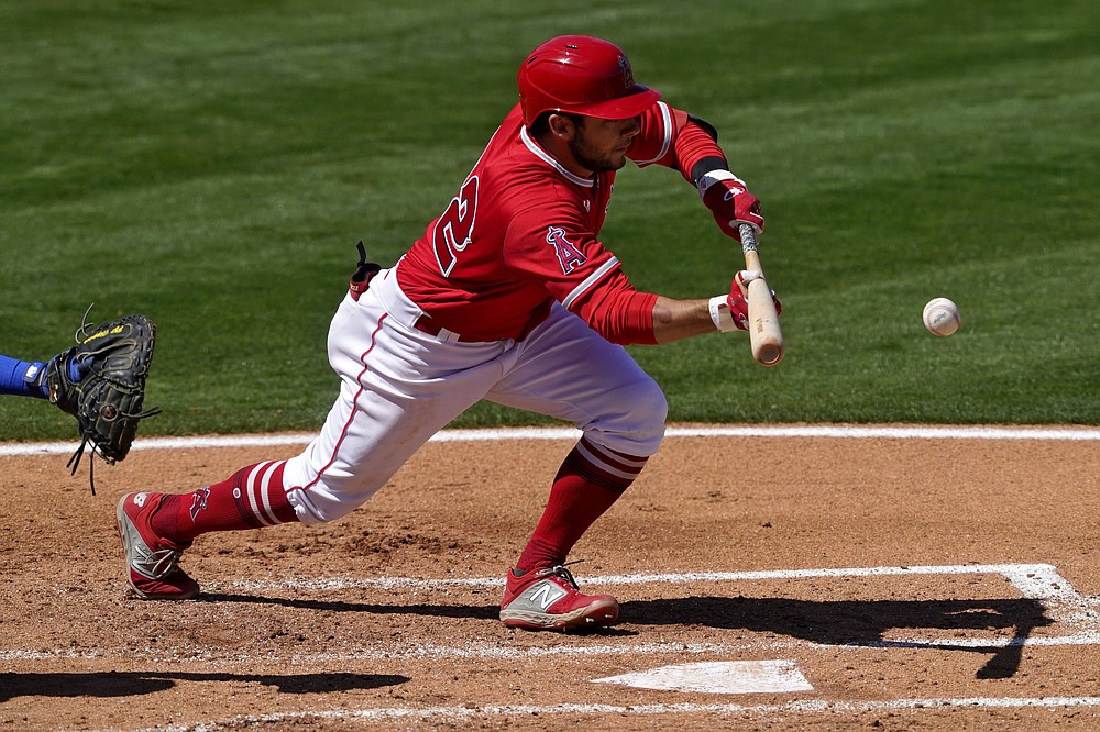 Los Angeles Angels' David Fletcher sacrifice bunts during the second inning of a spring training baseball game against the Chicago Cubs, Monday, March 22, 2021, in Tempe, Ariz. (AP Photo/Matt York)