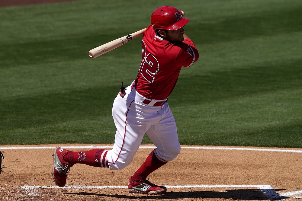 Los Angeles Angels' David Fletcher follows through on a double against the Oakland Athletics during the first inning of a spring training baseball game, Saturday, March 20, 2021, in Tempe, Ariz. (AP Photo/Matt York)