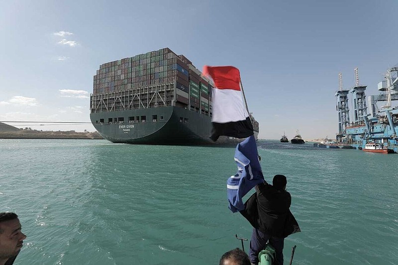 In this photo released by Suez Canal Authority, the Ever Given, a Panama-flagged cargo ship is accompanied by Suez Canal tugboats as it moves in the Suez Canal, Egypt, Monday, March 29, 2021. Salvage teams on Monday set free a colossal container ship that has halted global trade through the Suez Canal, bringing an end to a crisis that for nearly a week had clogged one of the world's most vital maritime arteries.