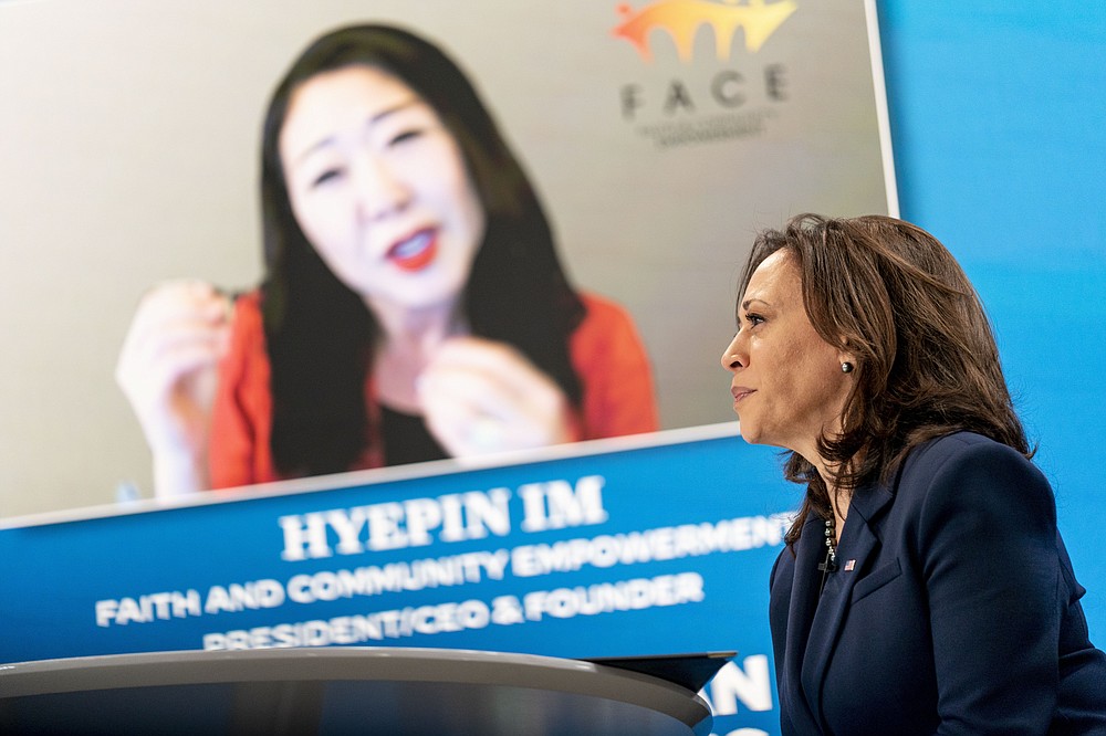 Faith and Community Empowerment President, CEO, and Founder Hyepin Im is displayed on a monitor behind Vice President Kamala Harris as she speaks during a virtual meeting with community leaders to discuss COVID-19 public education efforts in the South Court Auditorium in the Eisenhower Executive Office Building on the White House Campus, Thursday, April 1, 2021, in Washington. (AP Photo/Andrew Harnik)