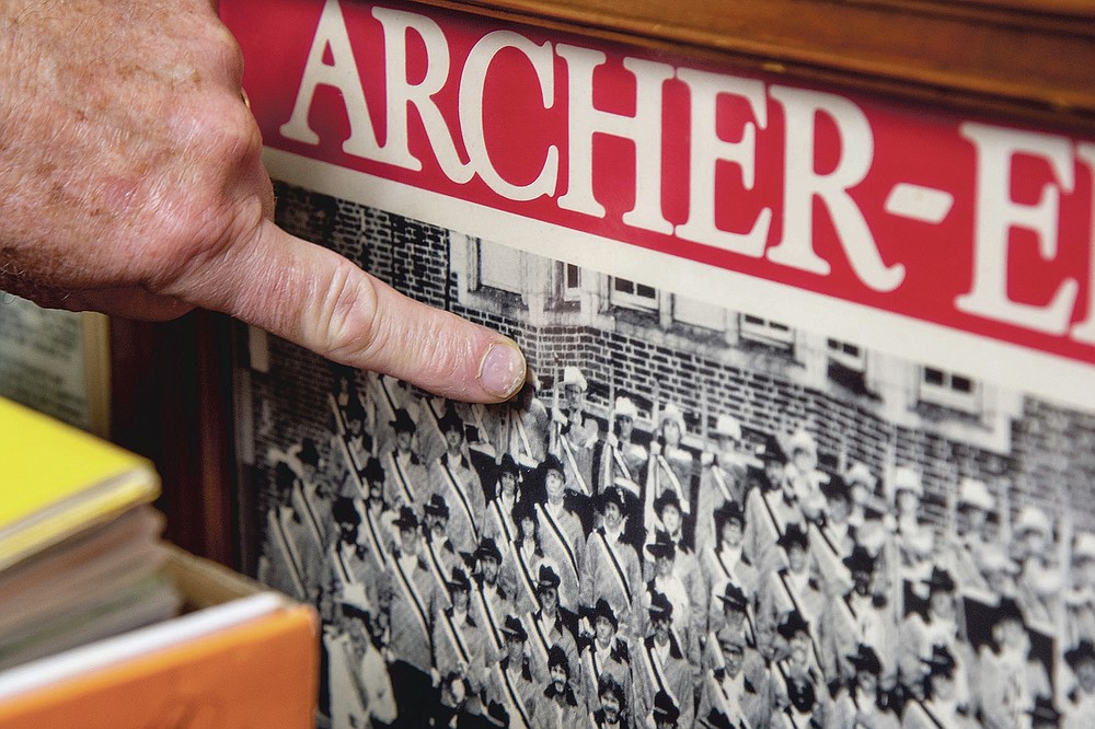 Bill Ives points to himself in a 1981 photo with the Archer-Epler Musketeers Drum and Bugle Corps, in Upper Darby, Pa., March 15, 2021. The marching band costumes, instruments, banners, flags, photos, programs, recordings, regalia, and memorabilia that Ives has assiduously amassed since 1990 — 24,000 pieces, and counting — are a showstopper. For now, they’re stored or displayed at Upper Darby’s venerable Archer-Epler VFW Post 979, the longtime headquarters of the Musketeers Drum and Bugle Corps. (Tom Gralish/The Philadelphia Inquirer via AP)