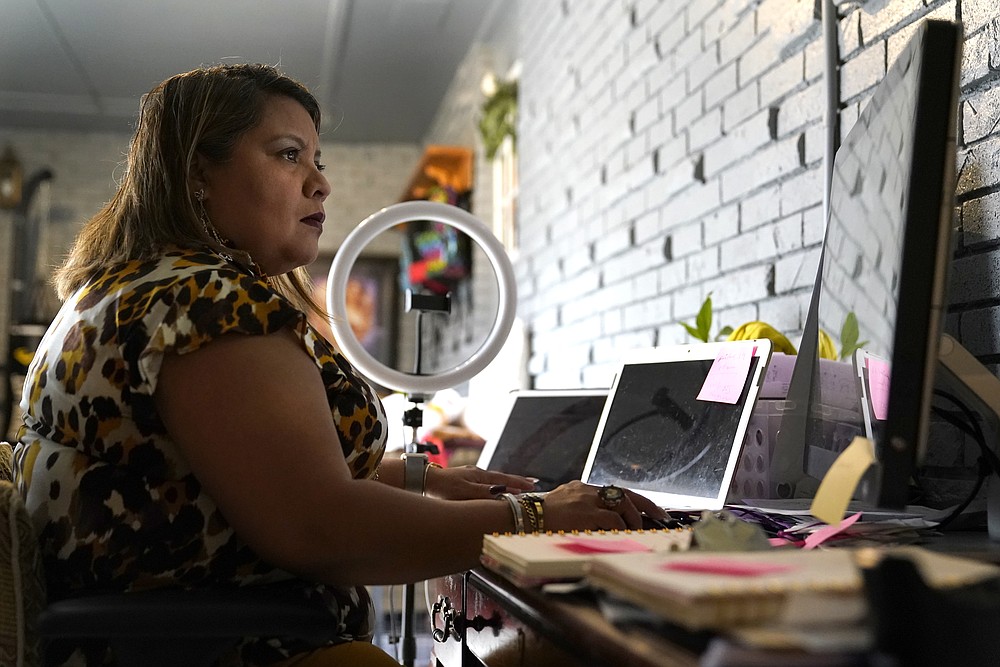 Irma Chavez works in her home office on Tuesday, March 9, in Springdale. Chavez came to the United States from her home in El Salvador in 1994 when she was 18 and later was granted temporary protected status.