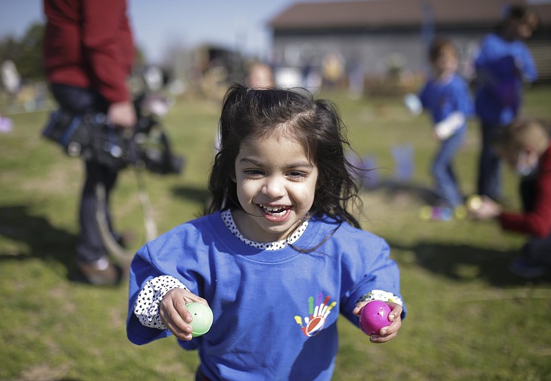 Isabella Owen, 2, of Centerton holds Easter eggs she collected, Friday at 10107 Andy Buck Road in Pea Ridge. No Limit Pediatric Therapies held its first special needs friendly Easter egg hunt in celebration of World Autism Awareness Day. 
(NWA Democrat-Gazette/Charlie Kaijo)
