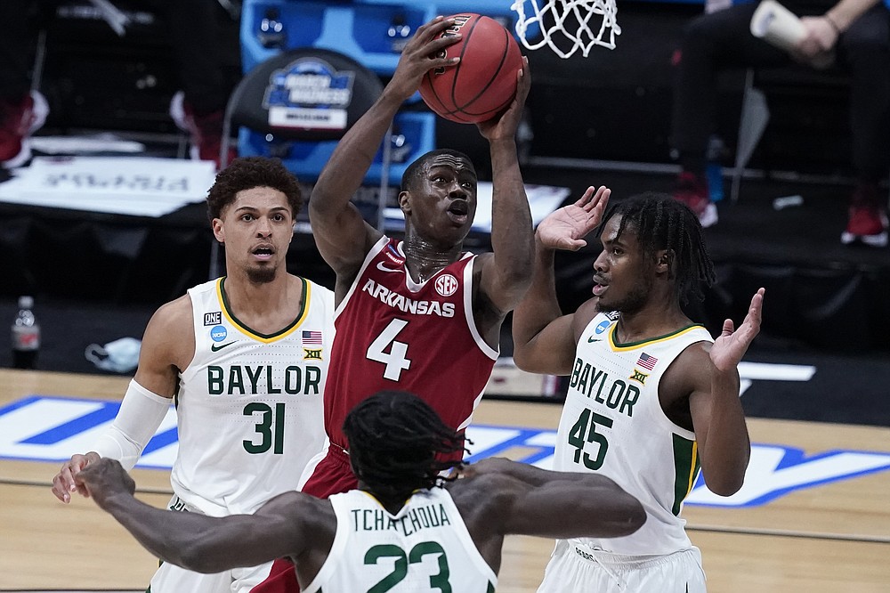 Arkansas guard Davonte Davis (4) drives on Baylor guard Davion Mitchell (45) and Jonathan Tchamwa Tchatchoua (23) as MaCio Teague (31) looks on during the second half of an Elite 8 game in the NCAA men's college basketball tournament at Lucas Oil Stadium, Monday, March 29, 2021, in Indianapolis. (AP Photo/Darron Cummings)