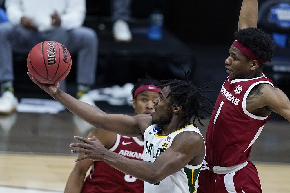 Baylor guard Davion Mitchell drives to the basket ahead of Arkansas guard JD Notae (1) during the second half of an Elite 8 game in the NCAA men's college basketball tournament at Lucas Oil Stadium, Monday, March 29, 2021, in Indianapolis. (AP Photo/Michael Conroy)