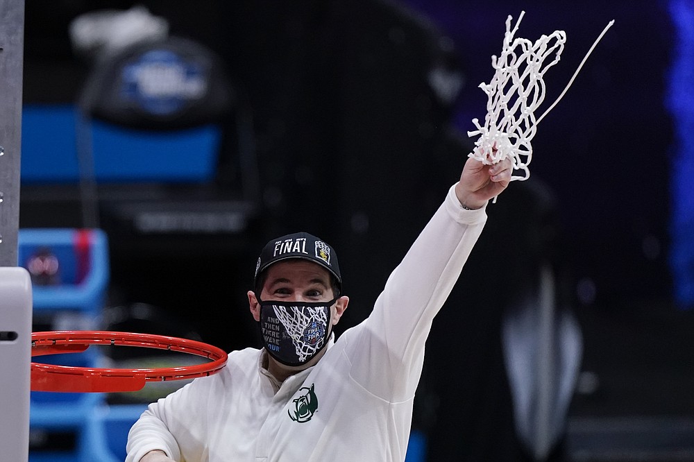 Baylor head coach Scott Drew holds up net after beating Arkansas during an Elite 8 game in the NCAA men's college basketball tournament at Lucas Oil Stadium, Tuesday, March 30, 2021, in Indianapolis. Baylor won 81-72. (AP Photo/Michael Conroy)